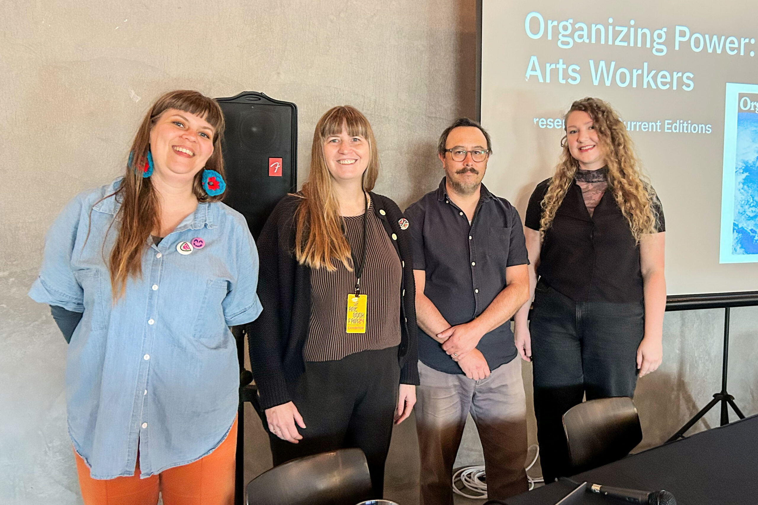 Four panelists standing in front of a projected slide reading 'Organizing Power: Arts Workers, presented by Current Editions' at the San Francisco Art Book Fair, July 2024.